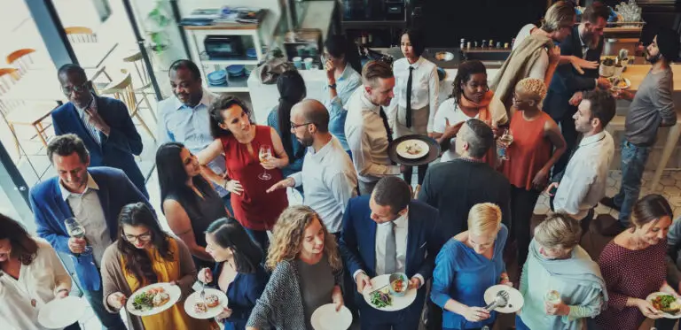 People of all genders mingling at a social gathering.